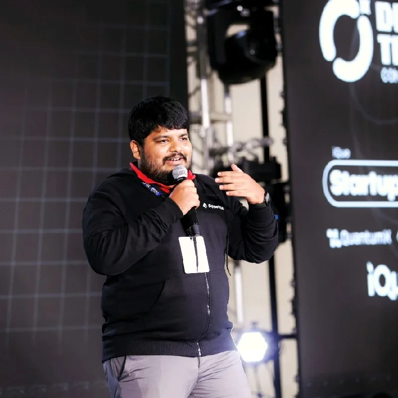 Ajmal Ibn Mohammed Althaf, Founder, CEO and Scientific Lead at QuantumX, speaking on stage